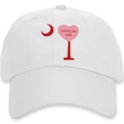 A Candy Heart Palmetto Moon Deluxe Cotton Hat for a Carolina Girl! Perfect for Valentine's Day, it features a pink candy heart on the South Carolina Palmetto Moon with Carolina Girl.